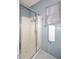 Bathroom featuring a shower with glass doors and a window with white towel at 7712 S 37Th Way, Phoenix, AZ 85042
