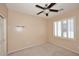Clean bedroom features neutral colors, a ceiling fan, and bright natural light at 7712 S 37Th Way, Phoenix, AZ 85042