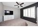 Modern bedroom boasts neutral colors, a ceiling fan, a large window, and white dresser at 7712 S 37Th Way, Phoenix, AZ 85042