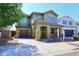 Two-story home featuring a covered front porch, desert landscaping, and attached garage at 7712 S 37Th Way, Phoenix, AZ 85042