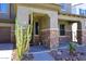 Inviting front entrance with desert landscaping, stone accents, and covered porch at 7712 S 37Th Way, Phoenix, AZ 85042