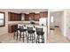 Kitchen with stainless steel appliances, granite countertops, breakfast bar, and dark wood cabinetry at 7712 S 37Th Way, Phoenix, AZ 85042