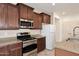 Well-equipped kitchen features stainless steel appliances, granite countertops and wooden cabinets at 7712 S 37Th Way, Phoenix, AZ 85042