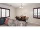 Cozy living room with a dining table, tile flooring, and a comfortable couch at 7712 S 37Th Way, Phoenix, AZ 85042