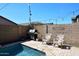 Private backyard pool area with a stone patio, grill, seating, and string lights at 7712 S 37Th Way, Phoenix, AZ 85042