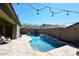Private pool with water feature and string lights, perfect for outdoor entertaining at 7712 S 37Th Way, Phoenix, AZ 85042