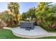 Private backyard oasis featuring a spa, lush landscaping, and a travertine deck, perfect for outdoor relaxation at 8618 E Via De Encanto --, Scottsdale, AZ 85258