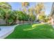 Lush backyard featuring artificial grass, desert landscaping, with large shade trees and desert perimeter plantings at 8618 E Via De Encanto --, Scottsdale, AZ 85258