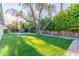Beautiful backyard with lush artificial turf, mature shade trees, and an outdoor spa; perfect for enjoying outdoor living at 8618 E Via De Encanto --, Scottsdale, AZ 85258