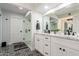 Well lit bathroom featuring double sinks, marble counters, and stylish black and white patterned floors at 8618 E Via De Encanto --, Scottsdale, AZ 85258