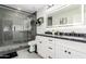 Bathroom featuring black marble counters, glass shower, and dual sinks at 8618 E Via De Encanto --, Scottsdale, AZ 85258