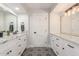Contemporary bathroom featuring dual sinks, marble counters, and stylish black and white patterned floors at 8618 E Via De Encanto --, Scottsdale, AZ 85258