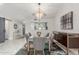 Dining room with modern chandelier, glass table with seating for six, accent rug, and built-in cabinet at 8618 E Via De Encanto --, Scottsdale, AZ 85258