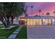 Modern home featuring a well-manicured lawn, sleek garage doors, and a charming walkway at 8618 E Via De Encanto --, Scottsdale, AZ 85258