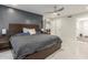 Modern main bedroom featuring a wood accent wall, ceiling fan, and marble tile flooring at 8618 E Via De Encanto --, Scottsdale, AZ 85258