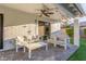 This covered patio features comfortable seating, a ceiling fan, and soft lighting at 8618 E Via De Encanto --, Scottsdale, AZ 85258