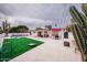 Expansive backyard featuring a patio, fire pit, outdoor seating, lawn games, and drought-resistant landscaping at 8725 E Vista Dr, Scottsdale, AZ 85250