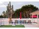 Spacious backyard featuring a pool, lounge chairs, cornhole game, and desert landscaping at 8725 E Vista Dr, Scottsdale, AZ 85250