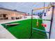 Spacious backyard with artificial turf, lawn games, patio, and plenty of space for activities at 8725 E Vista Dr, Scottsdale, AZ 85250