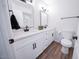 Bright bathroom featuring double sinks, modern fixtures, and wood tile floor at 8725 E Vista Dr, Scottsdale, AZ 85250