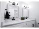 Bright bathroom featuring double sinks, modern fixtures, and clean white cabinets at 8725 E Vista Dr, Scottsdale, AZ 85250