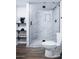 Updated bathroom with a glass shower, modern tiling, and floating shelves at 8725 E Vista Dr, Scottsdale, AZ 85250