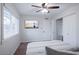 Comfortable bedroom with a ceiling fan, closet and window providing ample natural light at 8725 E Vista Dr, Scottsdale, AZ 85250