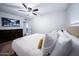 Bedroom features a king-sized bed, dark wood dresser, and flatscreen television at 8725 E Vista Dr, Scottsdale, AZ 85250