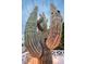 A towering Saguaro Cactus in the front yard beneath a partly cloudy sky at 8725 E Vista Dr, Scottsdale, AZ 85250