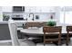 Bright kitchen and dining space with a table, island, and modern appliances at 8725 E Vista Dr, Scottsdale, AZ 85250