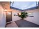 Inviting home entrance featuring a well-lit doorway and manicured garden, enhancing curb appeal at 8725 E Vista Dr, Scottsdale, AZ 85250