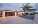 Charming home exterior with a well-maintained yard, mature palm trees, and a two-car garage at 8725 E Vista Dr, Scottsdale, AZ 85250