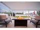 A beautiful outdoor living space with a fire pit, a yard with lawn games, and plenty of seating at 8725 E Vista Dr, Scottsdale, AZ 85250