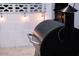 Close-up of a black Traeger grill on a patio with string lights, perfect for outdoor cooking and entertainment at 8725 E Vista Dr, Scottsdale, AZ 85250