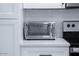 Detail of kitchen countertop with a silver Oster toaster oven next to a modern stovetop at 8725 E Vista Dr, Scottsdale, AZ 85250