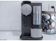Nespresso machine displayed on white countertops and white subway tile backsplash at 8725 E Vista Dr, Scottsdale, AZ 85250