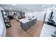 Spacious kitchen that opens to the living room featuring white cabinets, a large island, and stainless appliances at 8725 E Vista Dr, Scottsdale, AZ 85250