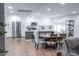 Open-concept kitchen featuring stainless steel appliances, white cabinets, and an adjacent dining area at 8725 E Vista Dr, Scottsdale, AZ 85250