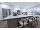 Kitchen with stainless appliances, white cabinets, dark hardware, and a large island with seating at 8725 E Vista Dr, Scottsdale, AZ 85250