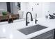 Stylish kitchen sink with a modern black faucet and a water filter tap on a quartz countertop at 8725 E Vista Dr, Scottsdale, AZ 85250