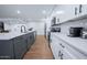 Beautiful kitchen with stainless appliances, white cabinets, wood-look floors, and an island at 8725 E Vista Dr, Scottsdale, AZ 85250