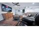 Well-lit living room featuring a ceiling fan, modern furniture, and flatscreen television at 8725 E Vista Dr, Scottsdale, AZ 85250