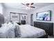 Comfortable main bedroom features a ceiling fan, closet with mirrored doors, and flatscreen TV at 8725 E Vista Dr, Scottsdale, AZ 85250