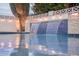 Beautiful pool with a tiled waterfall feature, creating a serene backyard oasis at 8725 E Vista Dr, Scottsdale, AZ 85250