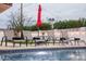Relaxing pool area with comfortable lounge chairs and an umbrella, ideal for enjoying sunny days at 8725 E Vista Dr, Scottsdale, AZ 85250