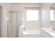 Bright bathroom featuring a separate shower, and a bathtub at 9512 E Kilarea Ave, Mesa, AZ 85209