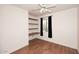 Bedroom with wood floors, shelving and a window at 9512 E Kilarea Ave, Mesa, AZ 85209