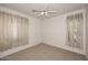 Neutral bedroom featuring carpet, sheer curtains, and a ceiling fan at 9512 E Kilarea Ave, Mesa, AZ 85209