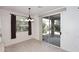 Dining area with tile floors, dark curtains, sliding glass door to patio and decorative chandelier at 9512 E Kilarea Ave, Mesa, AZ 85209