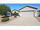 Exterior of a well-kept, single-story house with a two-car garage, complemented by a manicured front yard at 9512 E Kilarea Ave, Mesa, AZ 85209
